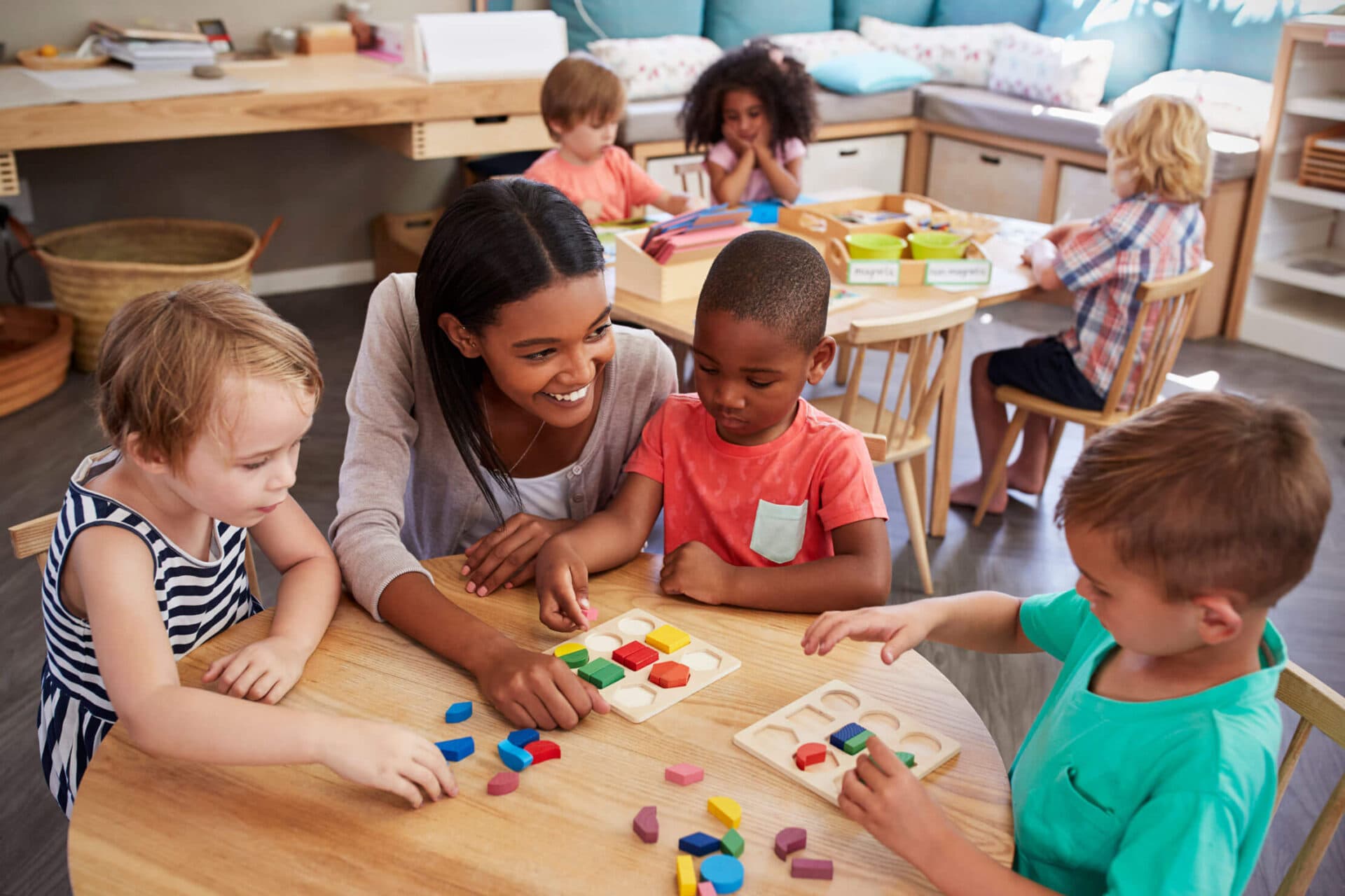 A teacher engaging children in a classroom activity