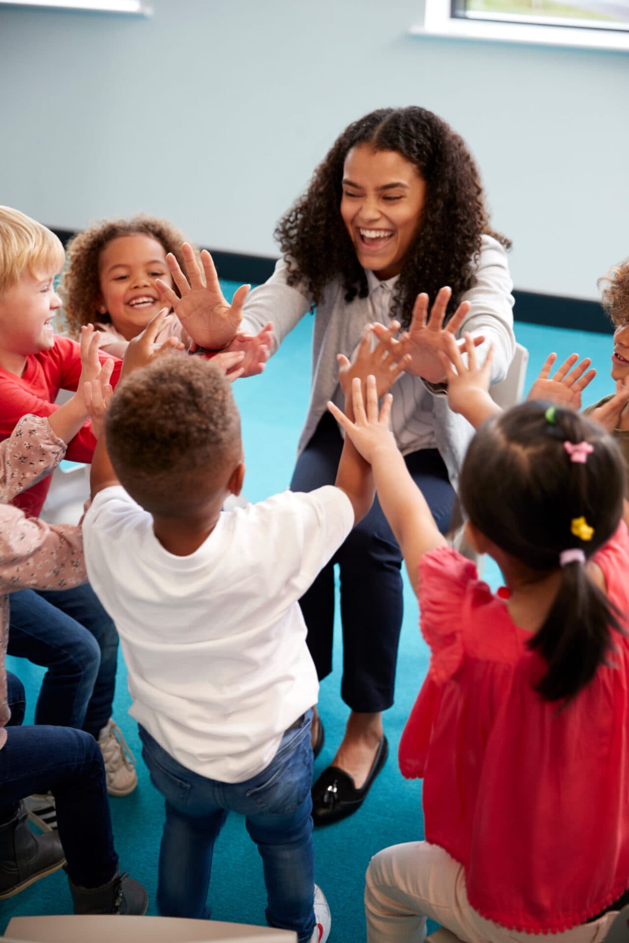A Kids Discovery teacher reading with children