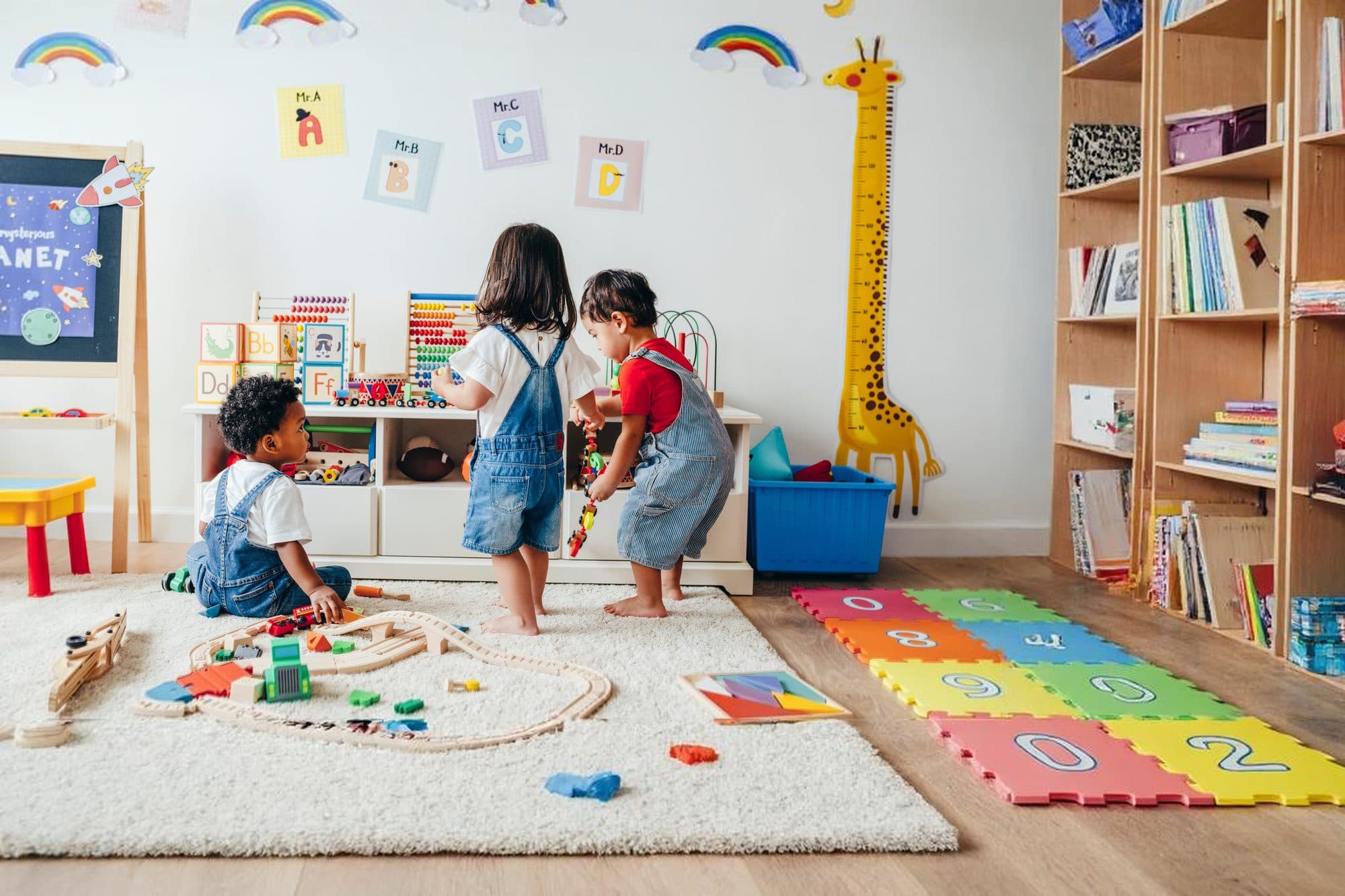 Toddlers playing in a colorful classroom